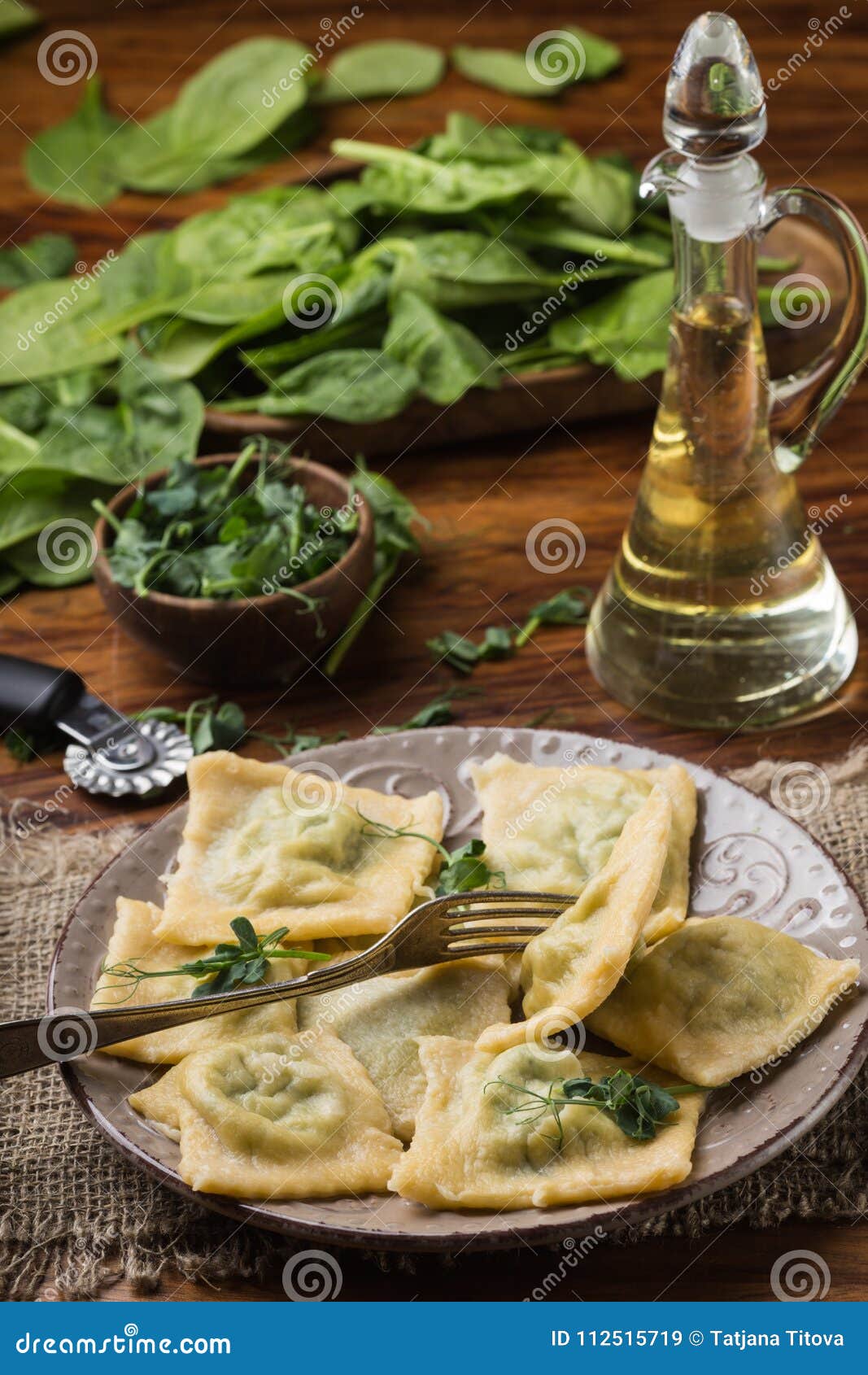 Ready Ravioli in a Plate, Spinach, Olive Oil in a Jar Stock Image