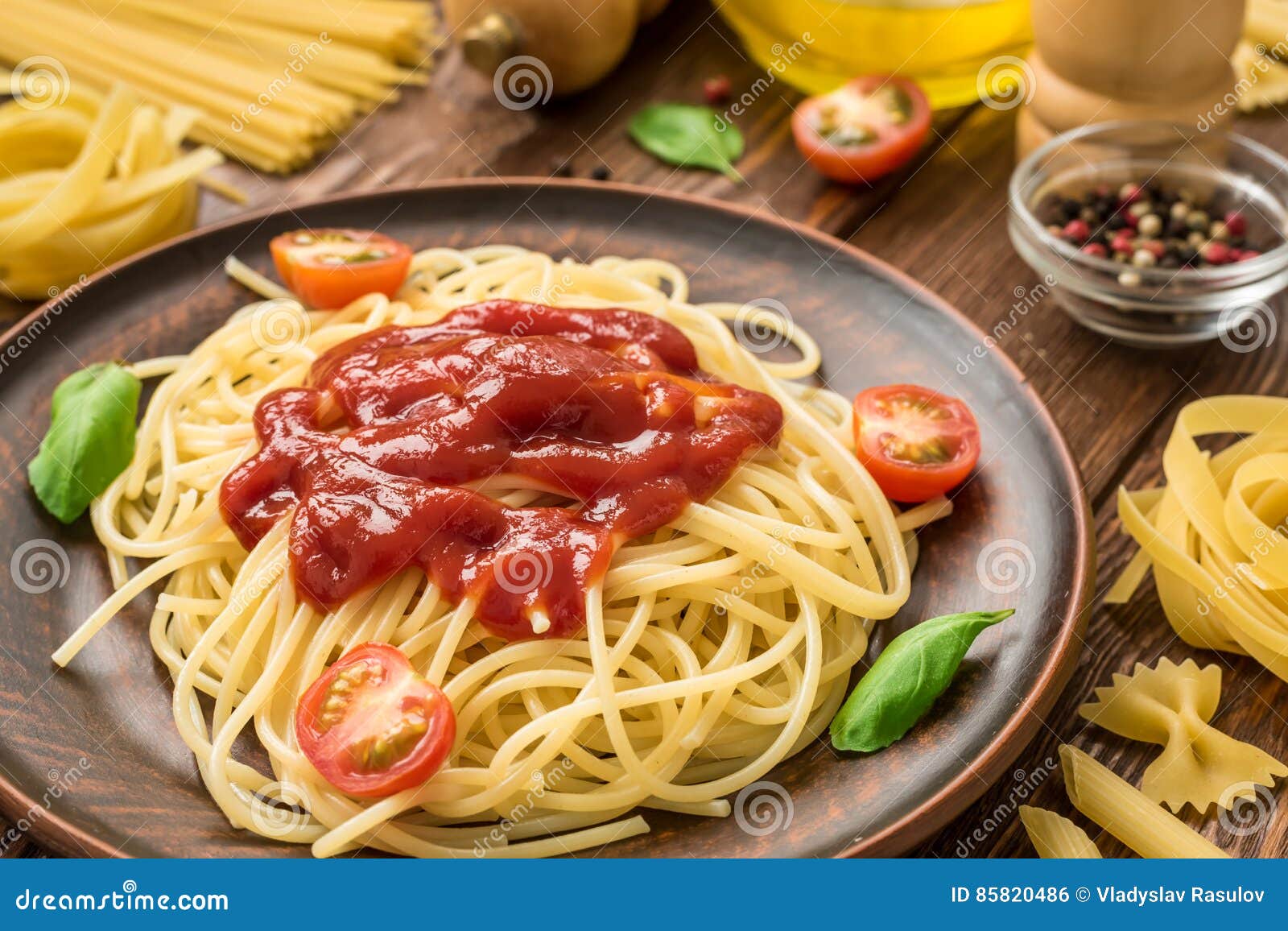 Ready To Eat Spaghetti with Ketchup, Tomatoes and Basil Stock Photo
