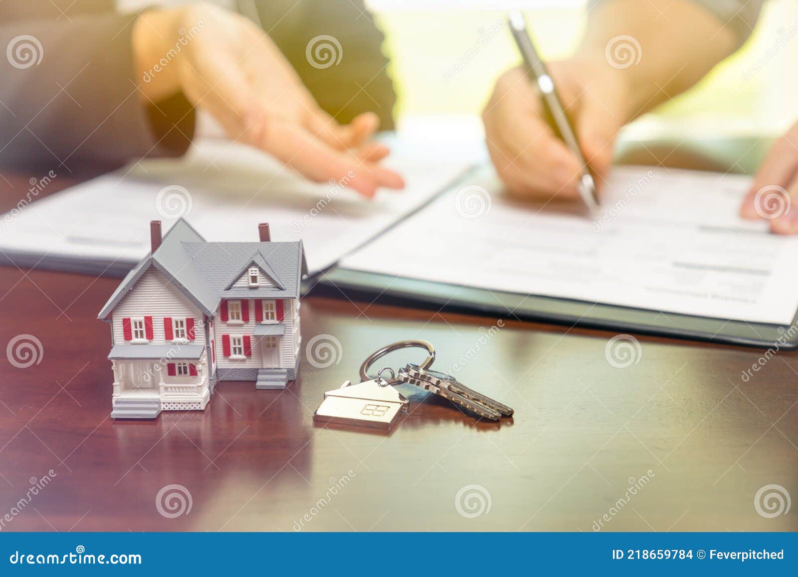 Real Estate Agent and Customer Sign Contract Papers with House Keys and ...