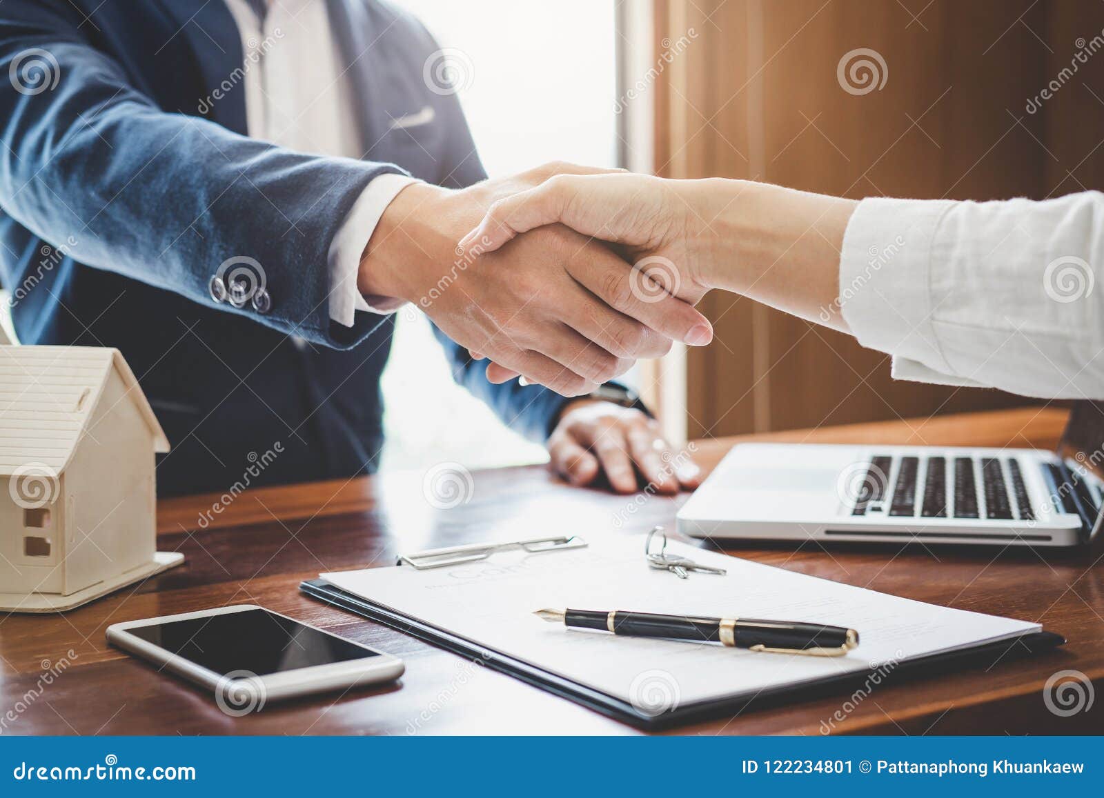 real estate agent and customers shaking hands together celebrating finished contract after about home insurance and investment lo