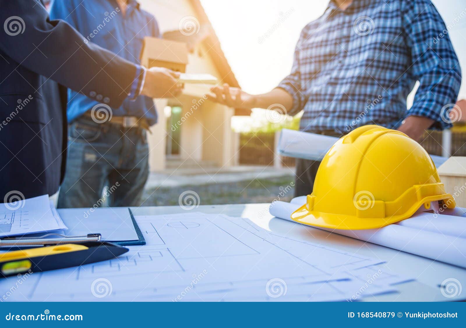 Real Estate Agent Giving House Keys in Front of House Stand with