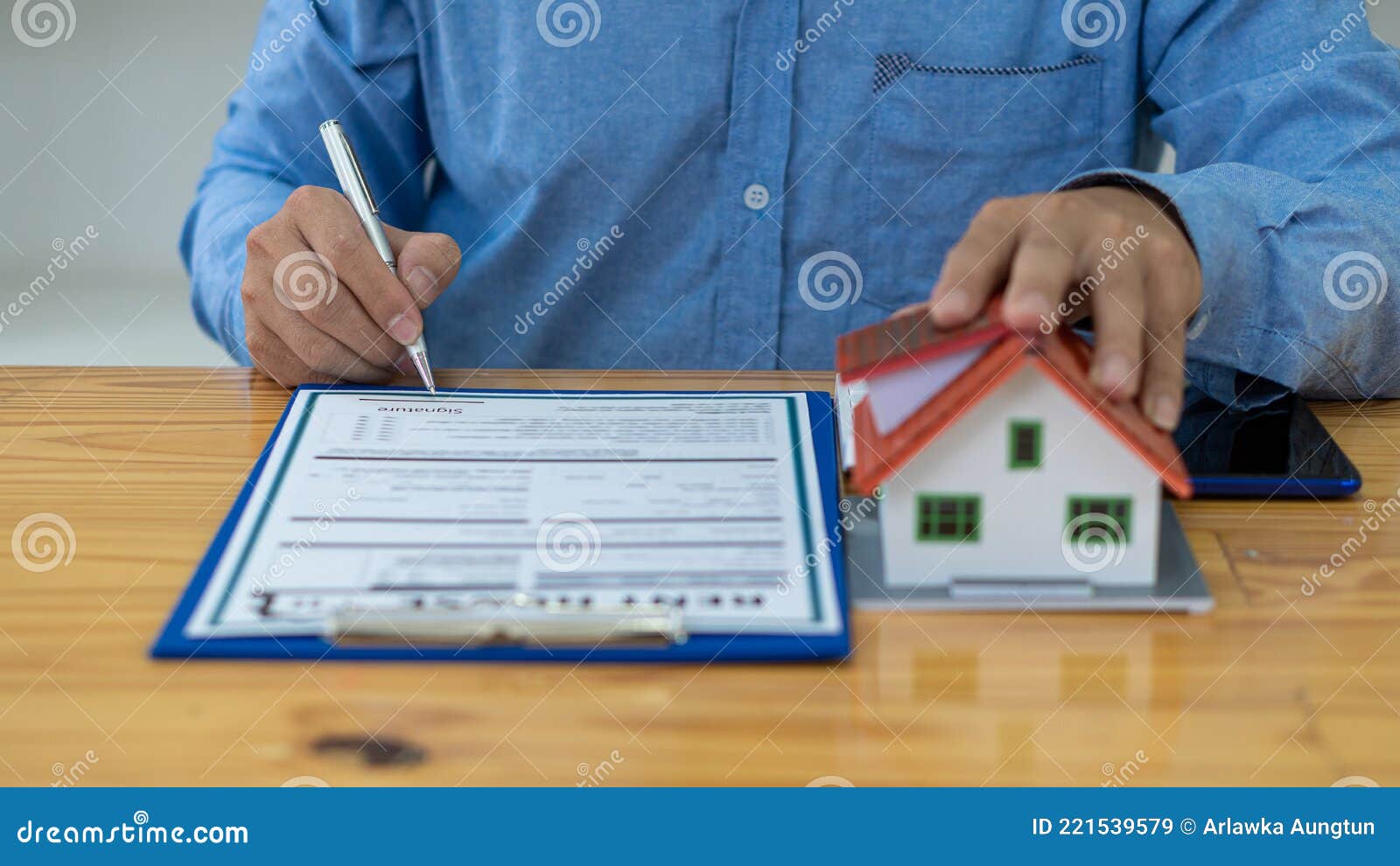 Real Estate Agents Work at Desks in Rooms with Paperwork and House