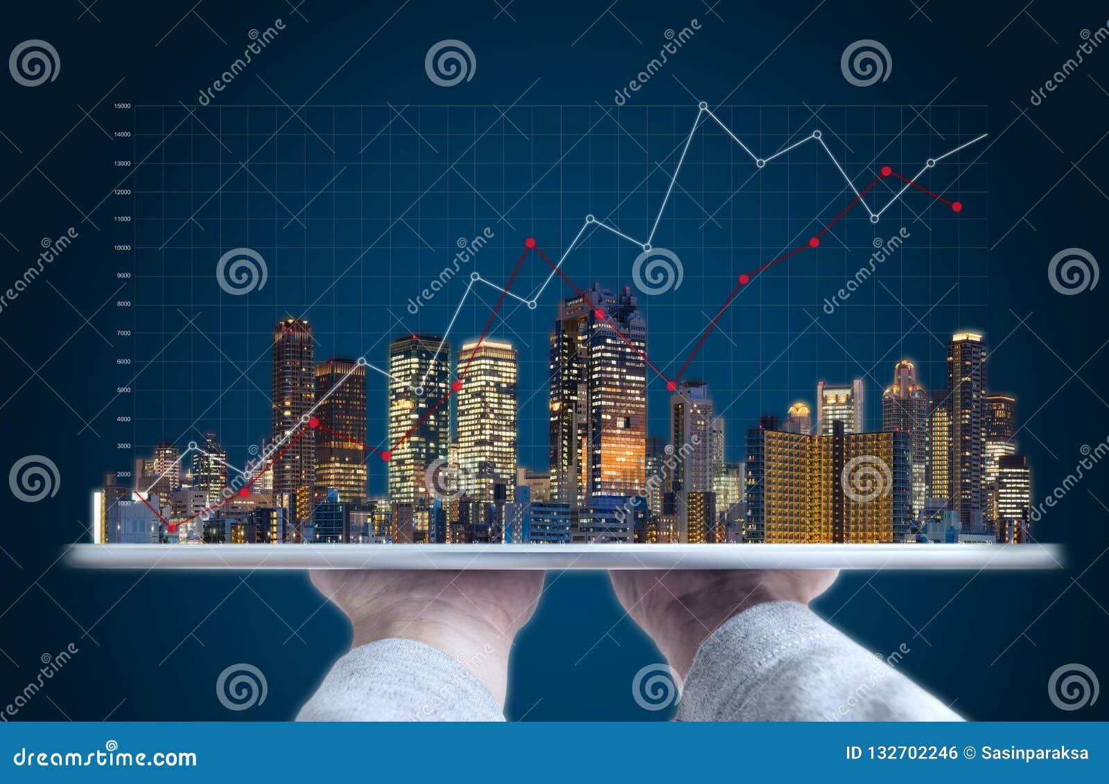 real estate business investment and building technology. hand holding digital tablet with buildings hologram and raising graph