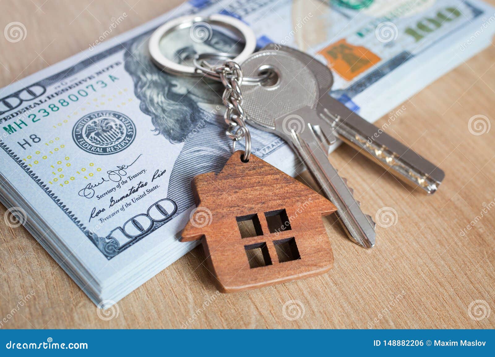 real estate investing concept. american dollar, cash and housing. keys close-up