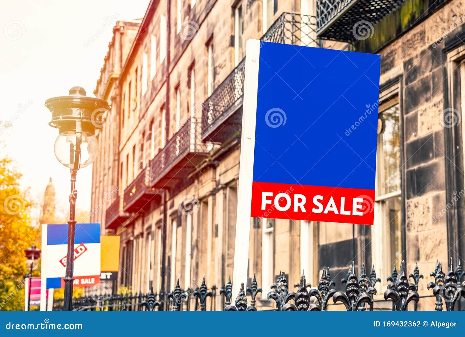 real estate sign in fornt of a house on sale