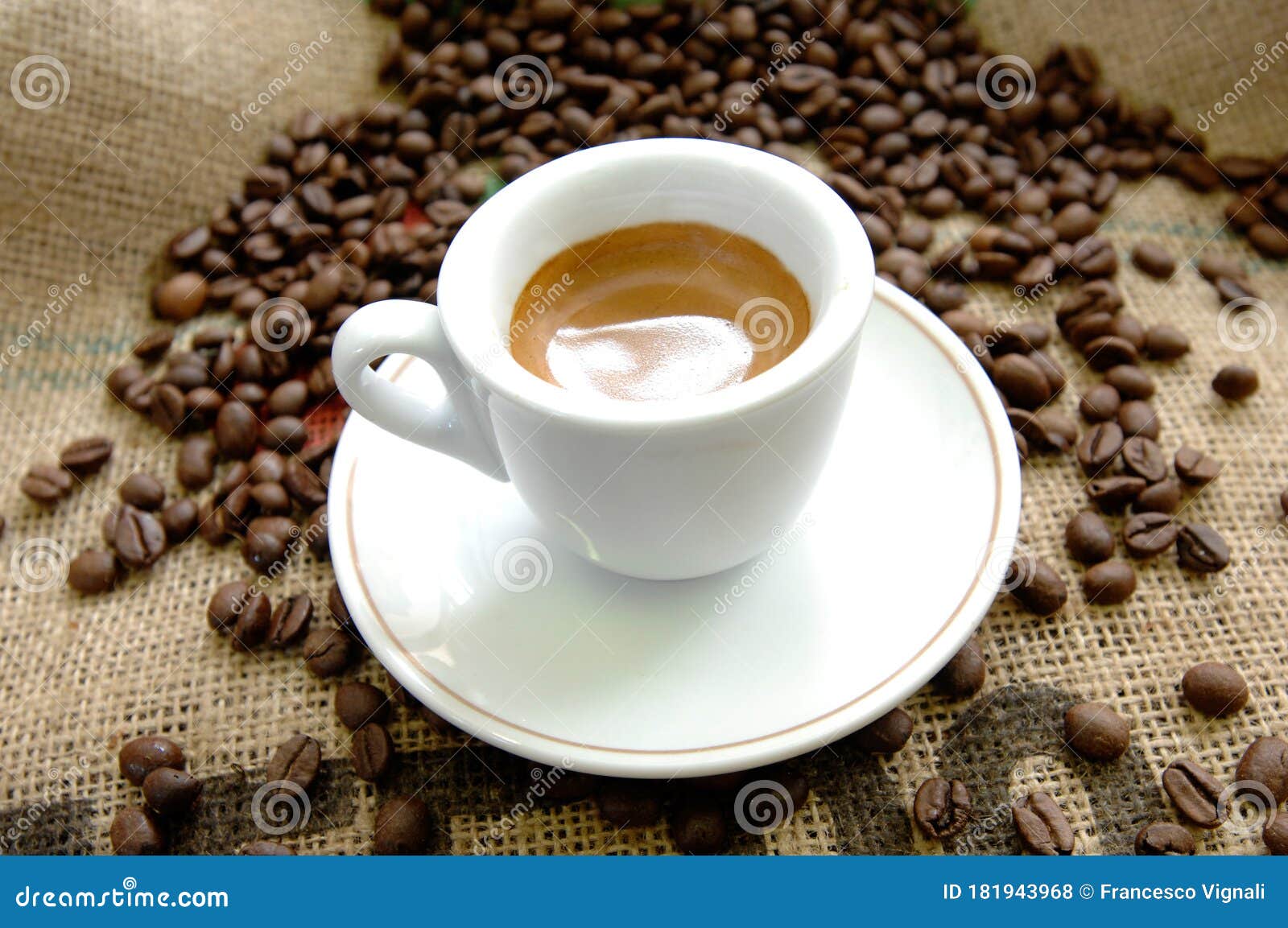 italian espresso cup near coffee beans on a yute sack