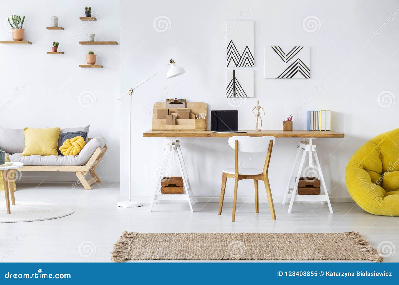 modern home office interior with graphics, desk, sofa and yellow pouf