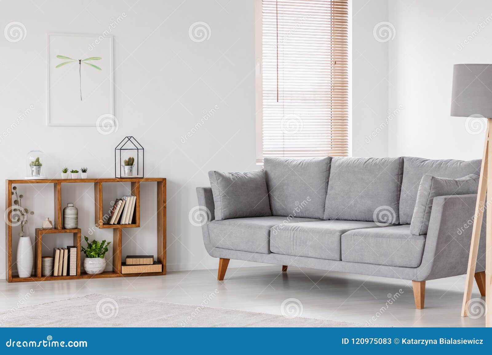 real photo of a scandi living room interior with gray settee sta