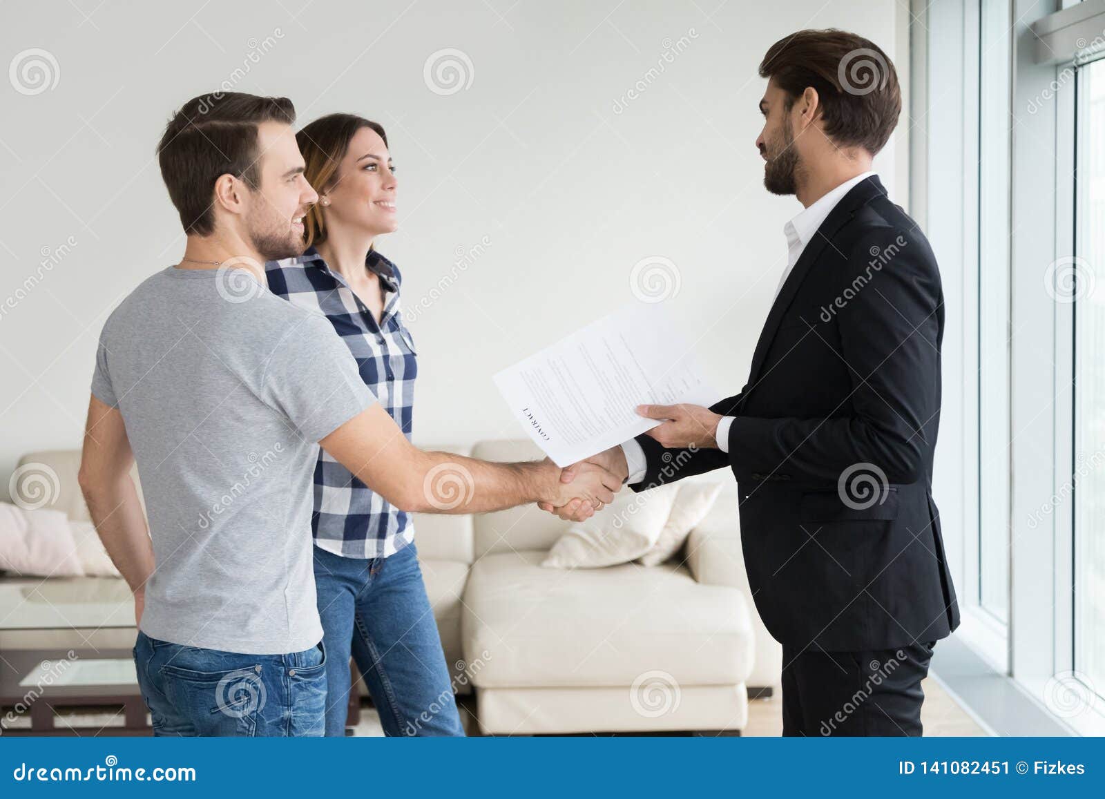 Realtor Or Landlord Handshaking Couple Tenants Make Real Estate Deal Stock Image Image Of 