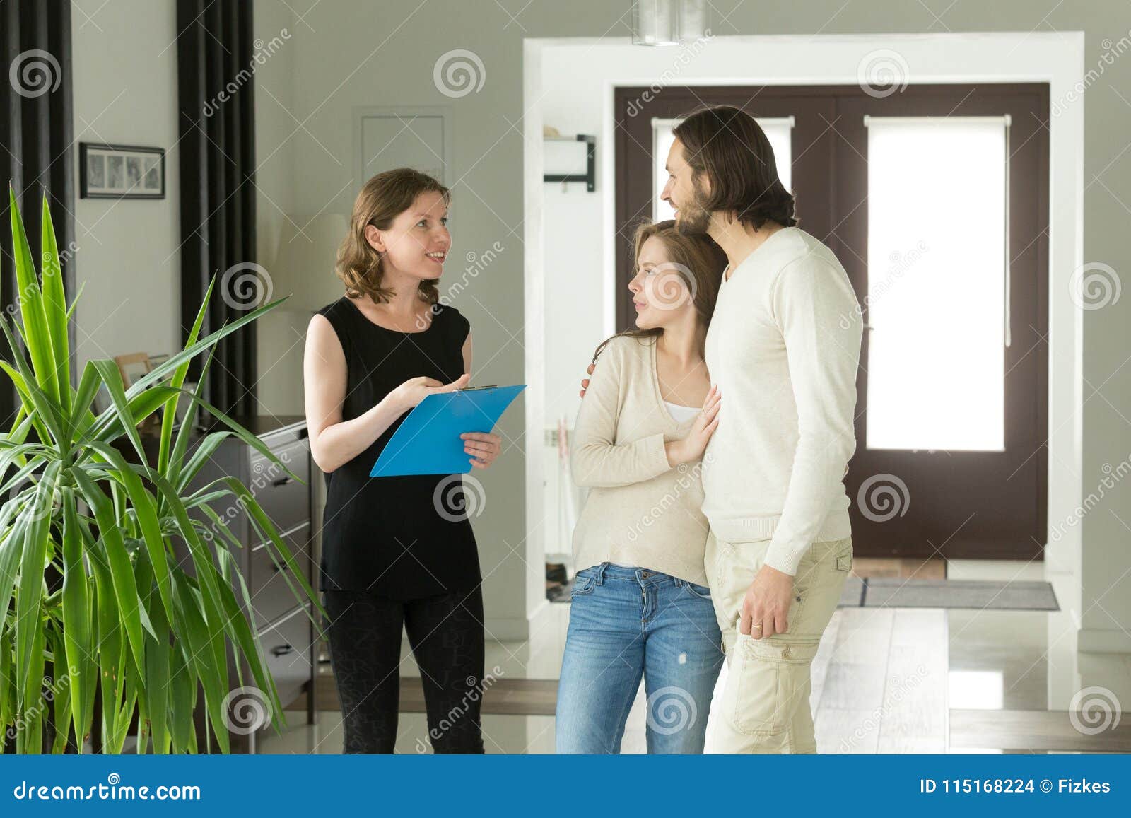 Realtor Or Landlord Showing Modern Luxury House To Couple Custom Stock 