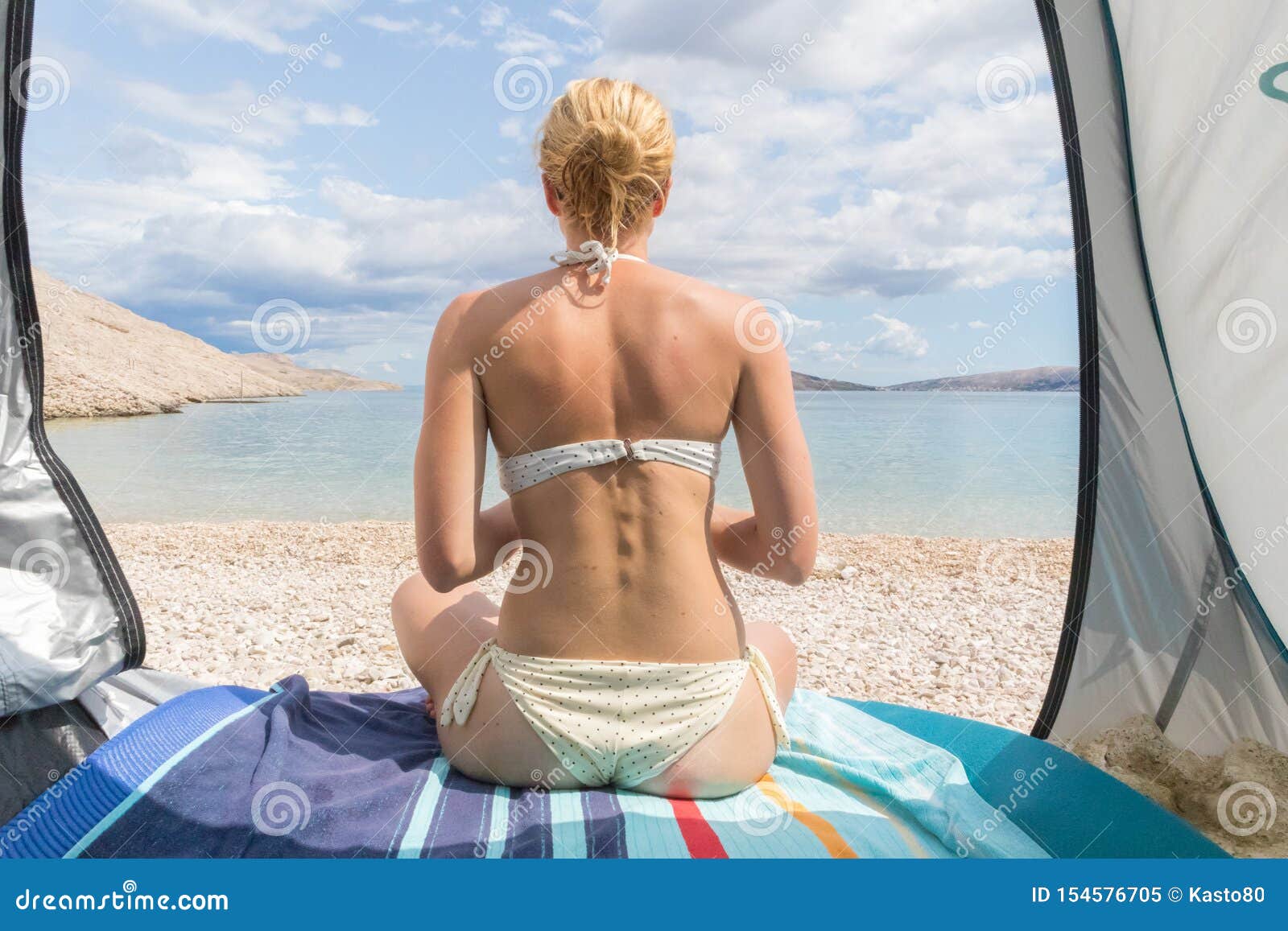 Rear View Of Beautiful Young Caucasian Woman Enjoying Summer Sun On