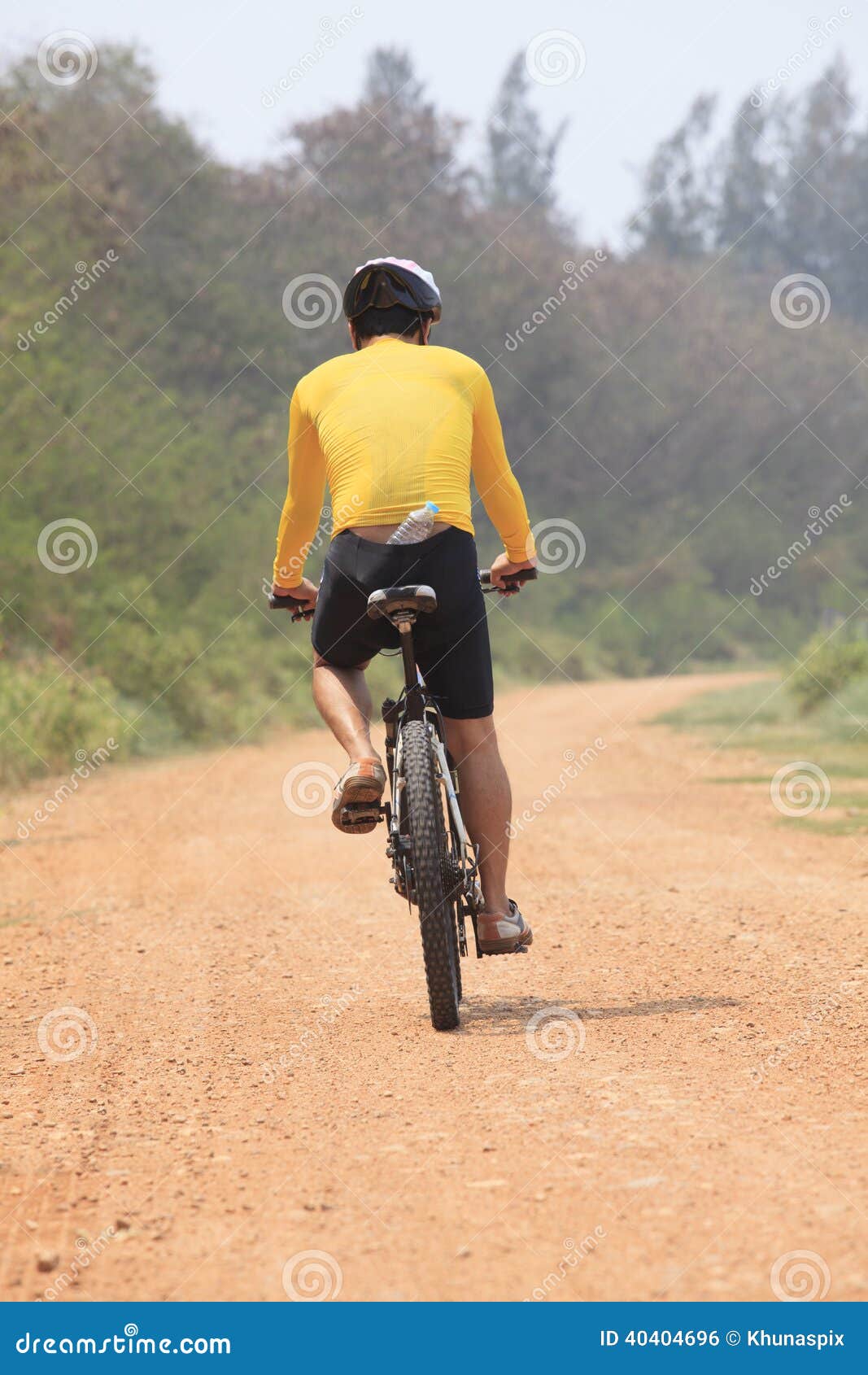 Download Rear View Of Bicycle Man Riding On Dirt Road With Drinking ...