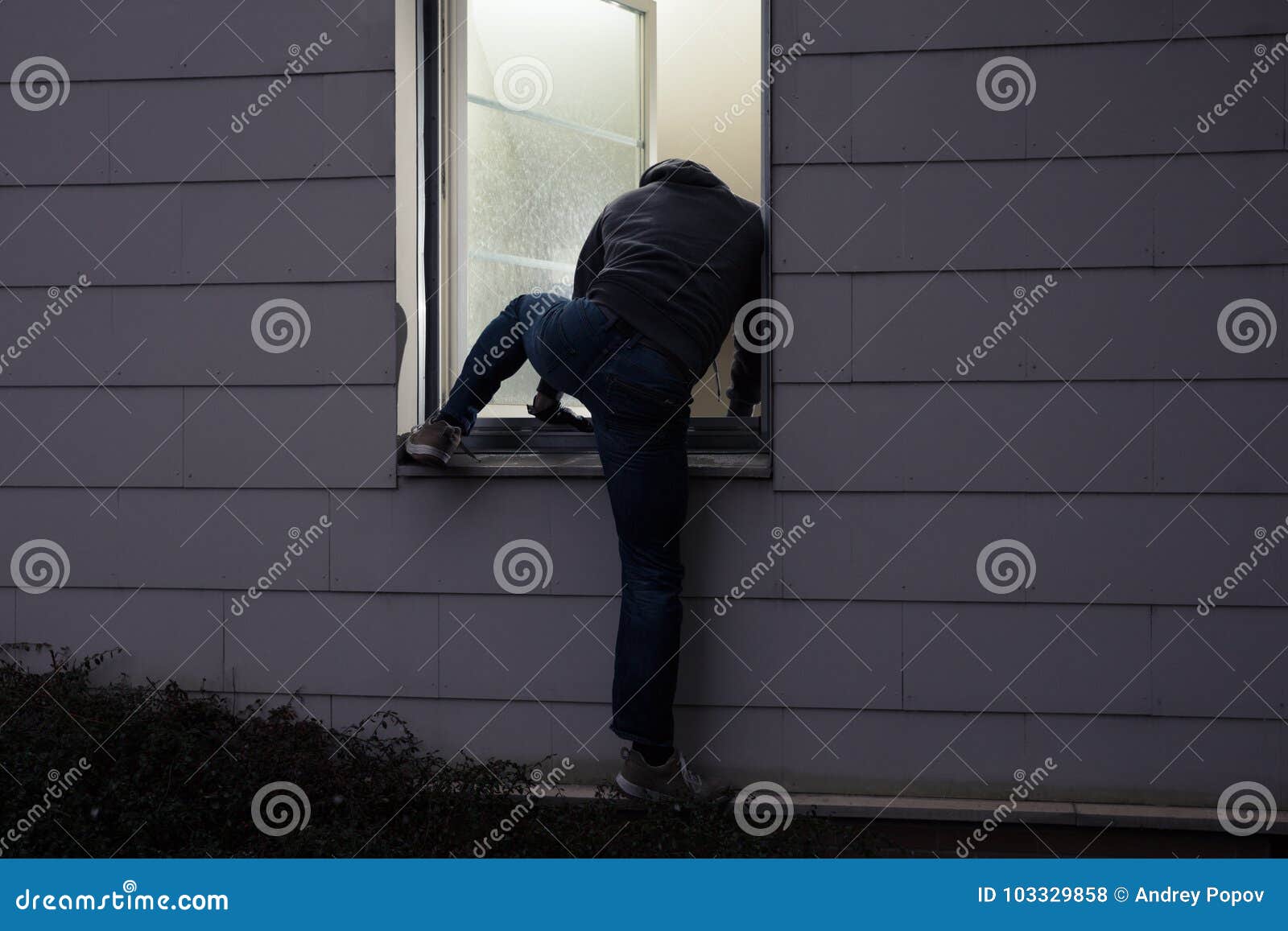 burglar entering house through window