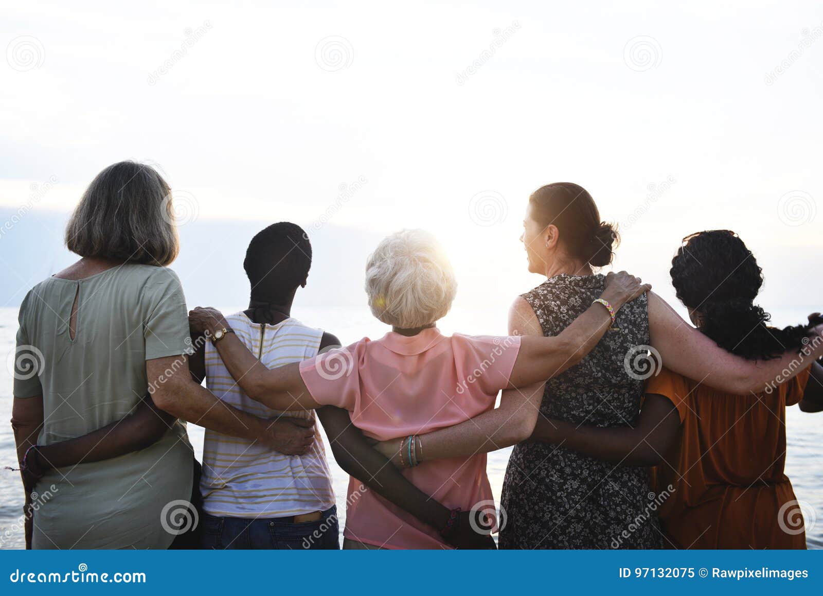 rear view of diverse senior women standing together at the beach