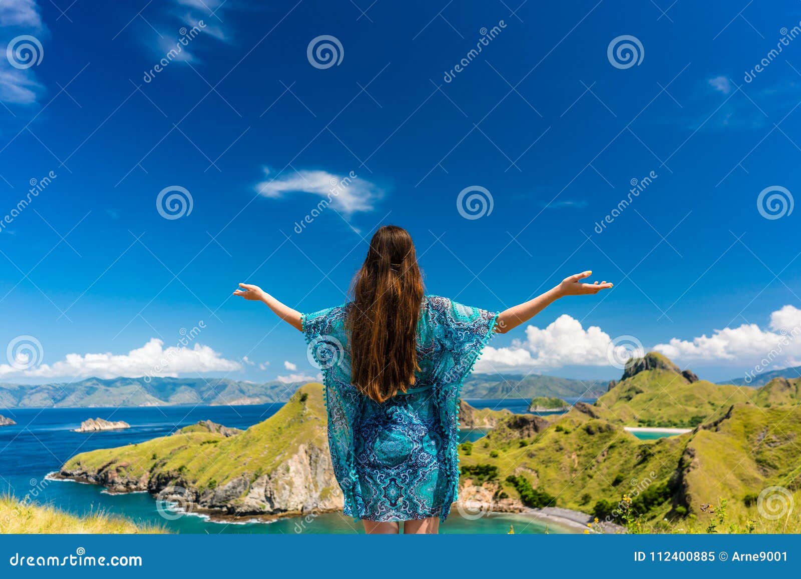 happy tourist enjoying the breeze during summer vacation in padar island