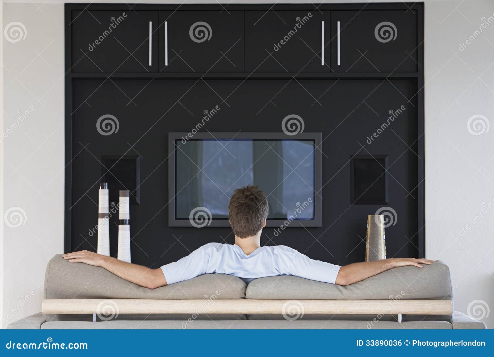 rear view of man watching television