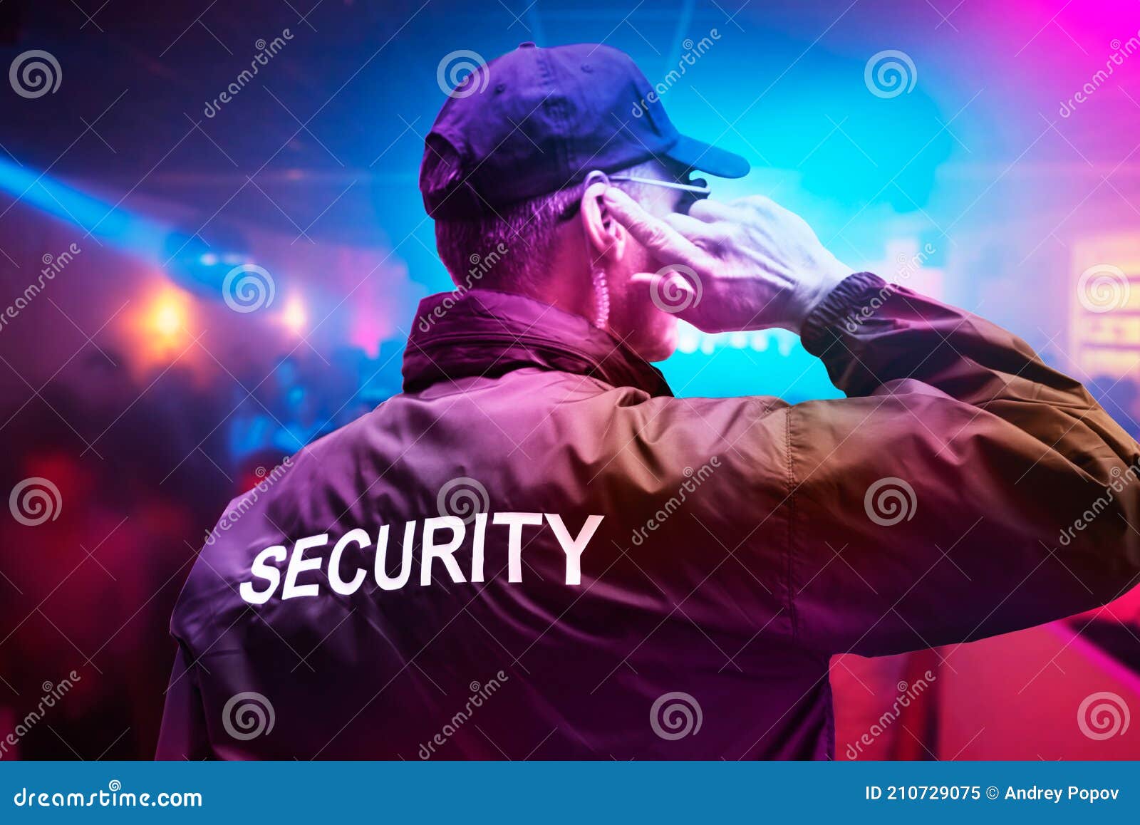 male security officer with earphones in night club