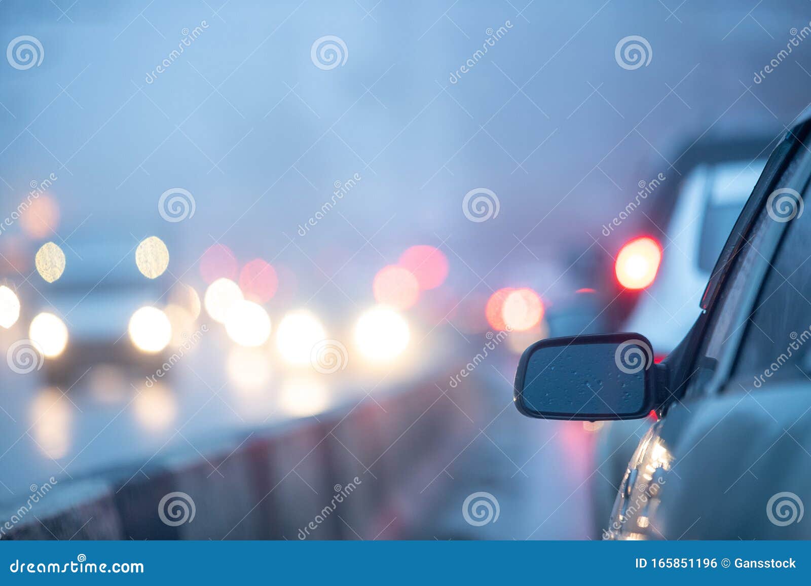Rear View Mirror on the Background of Blurry Headlights of ...