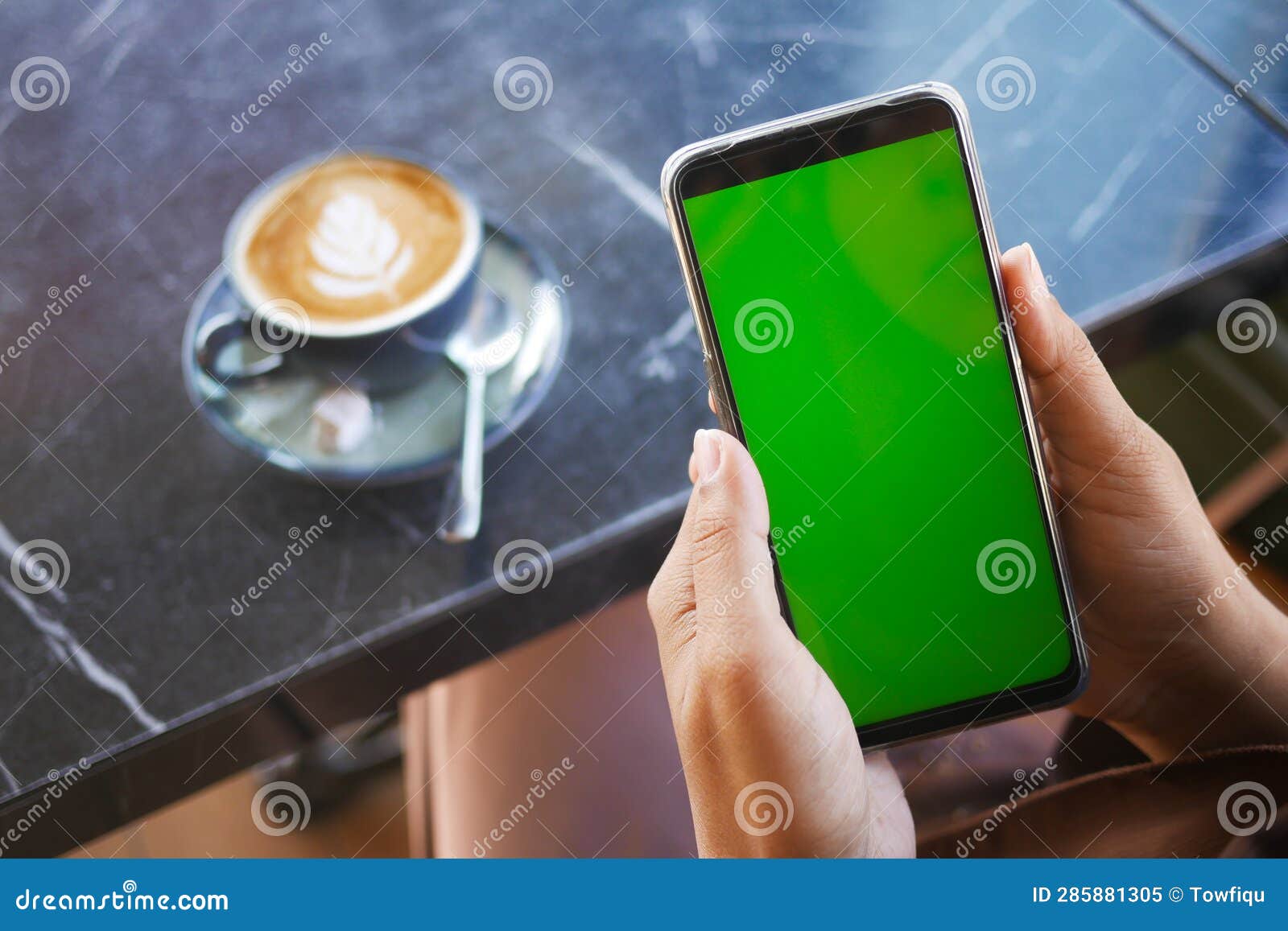 Rear View of Using Smart Phone with Green Screen and Coffee on Table