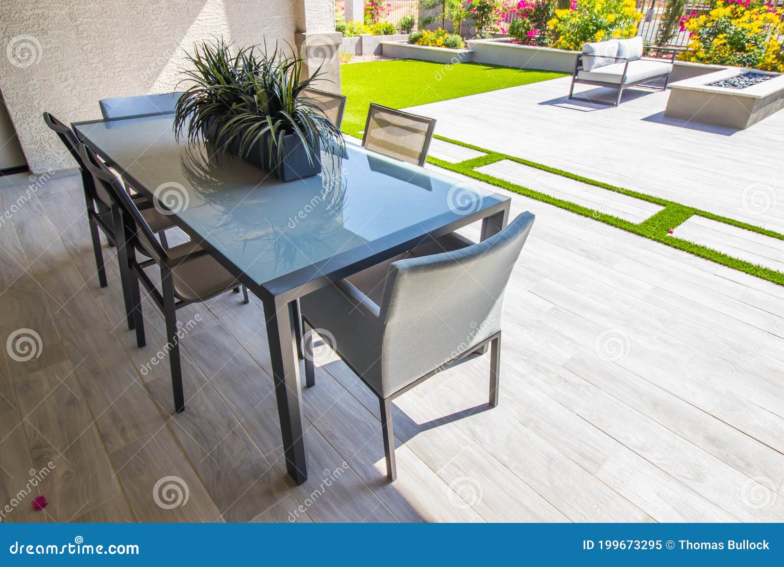 Rear Yard Covered Patio with Glass Table & Six Chairs Stock Image