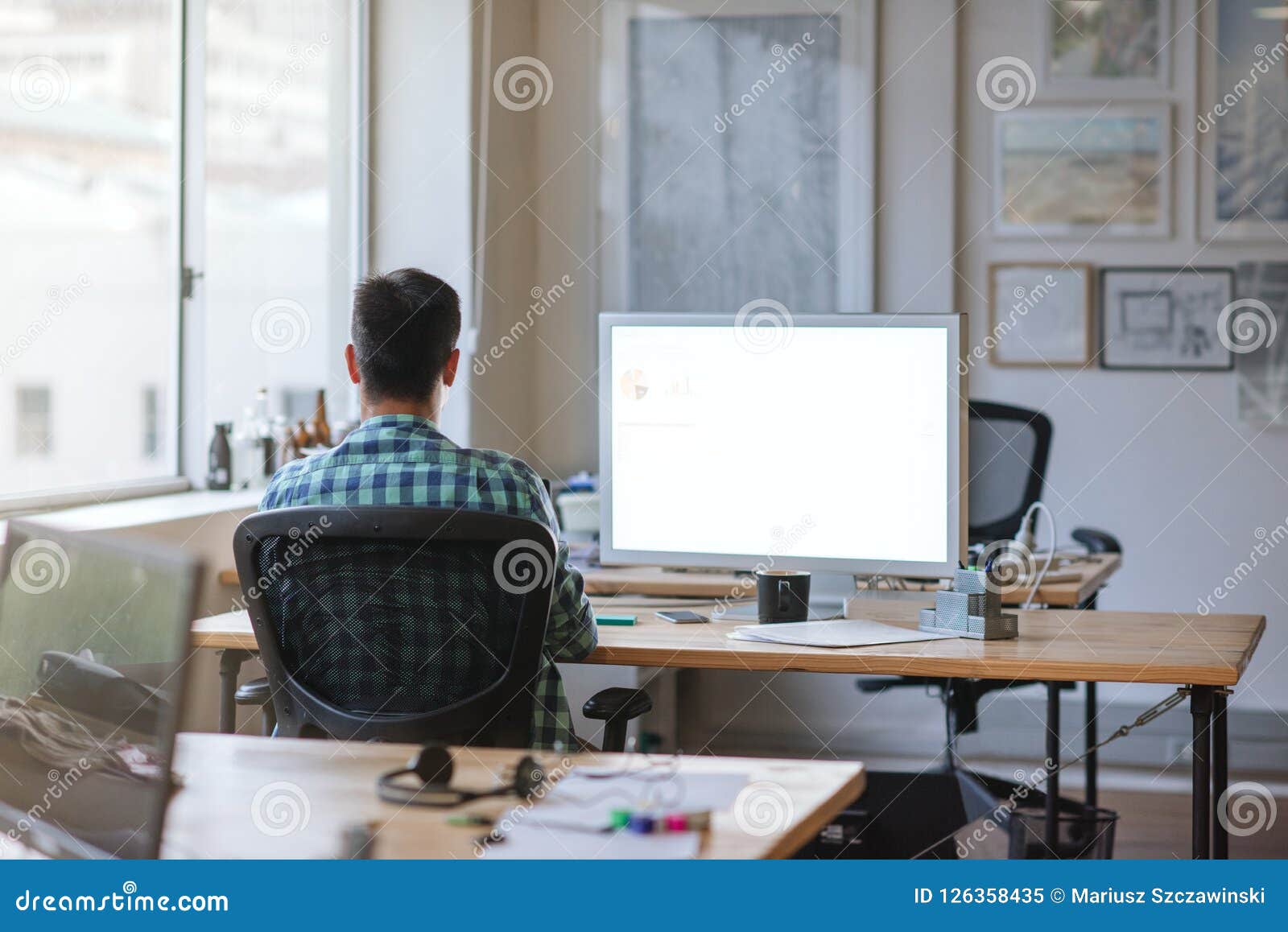 Young Designer Working Late At His Desk In An Office Stock Image