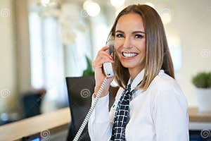 Receptionist Answering Phone At Hotel Front Desk Stock Photo Image Of 