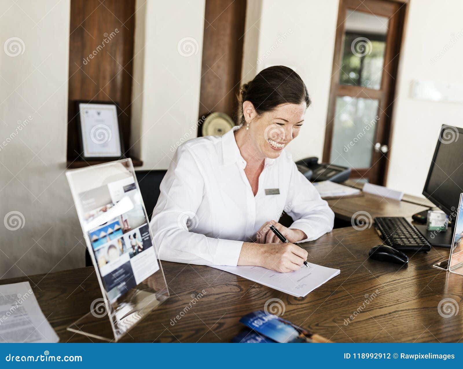 Receptionist Working At The Front Desk Stock Photo Image Of