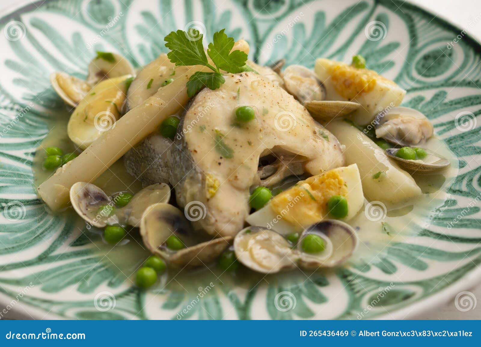 hake cooked basque style with green sauce, peas, egg and white asparagus.