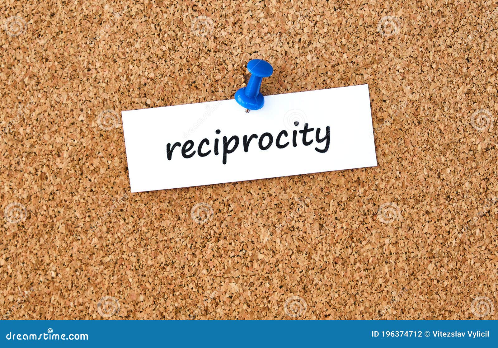 reciprocity. word written on a piece of paper, cork board background