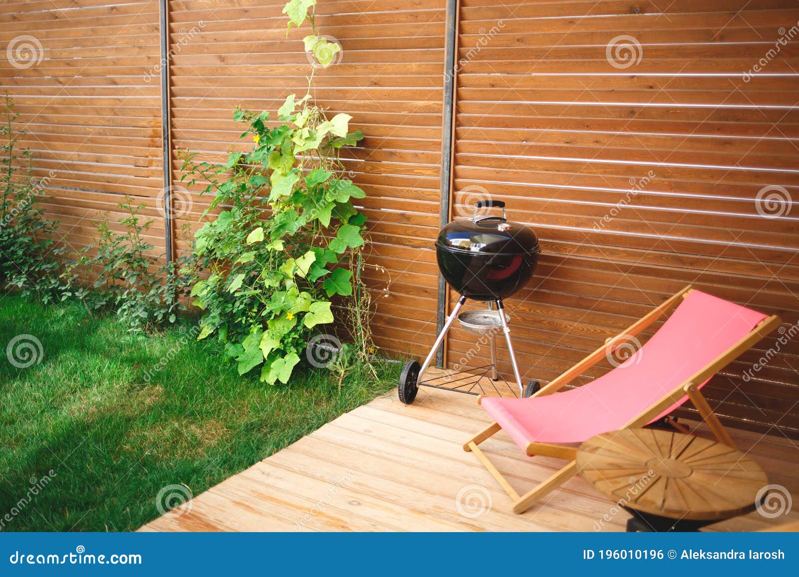 recreation area in the yard of the house: chairs, barbecue, table