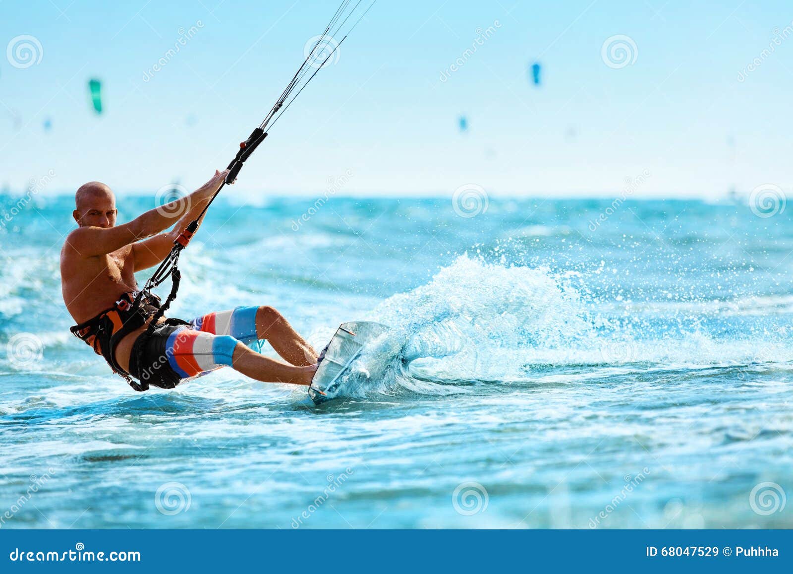 recreational sports. man kiteboarding in sea water. extreme sport action