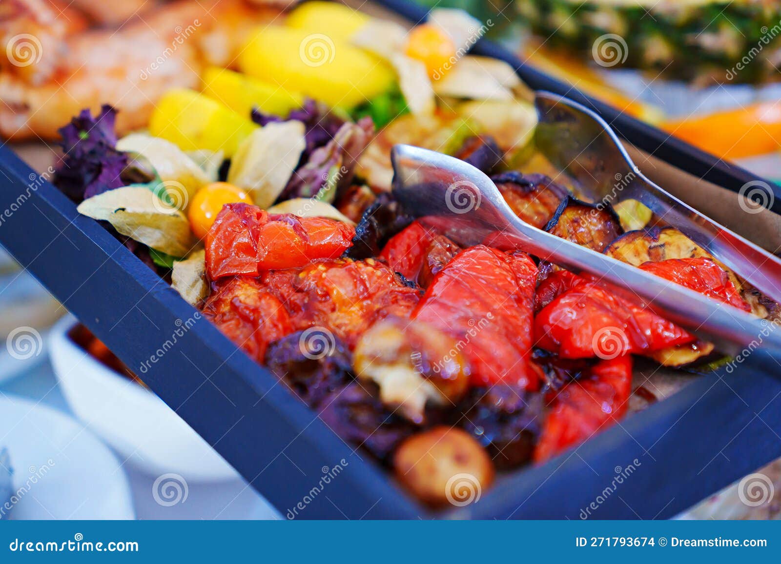 Rectangular Black Dish with Grilled Fish and Vegetables. Stock Photo