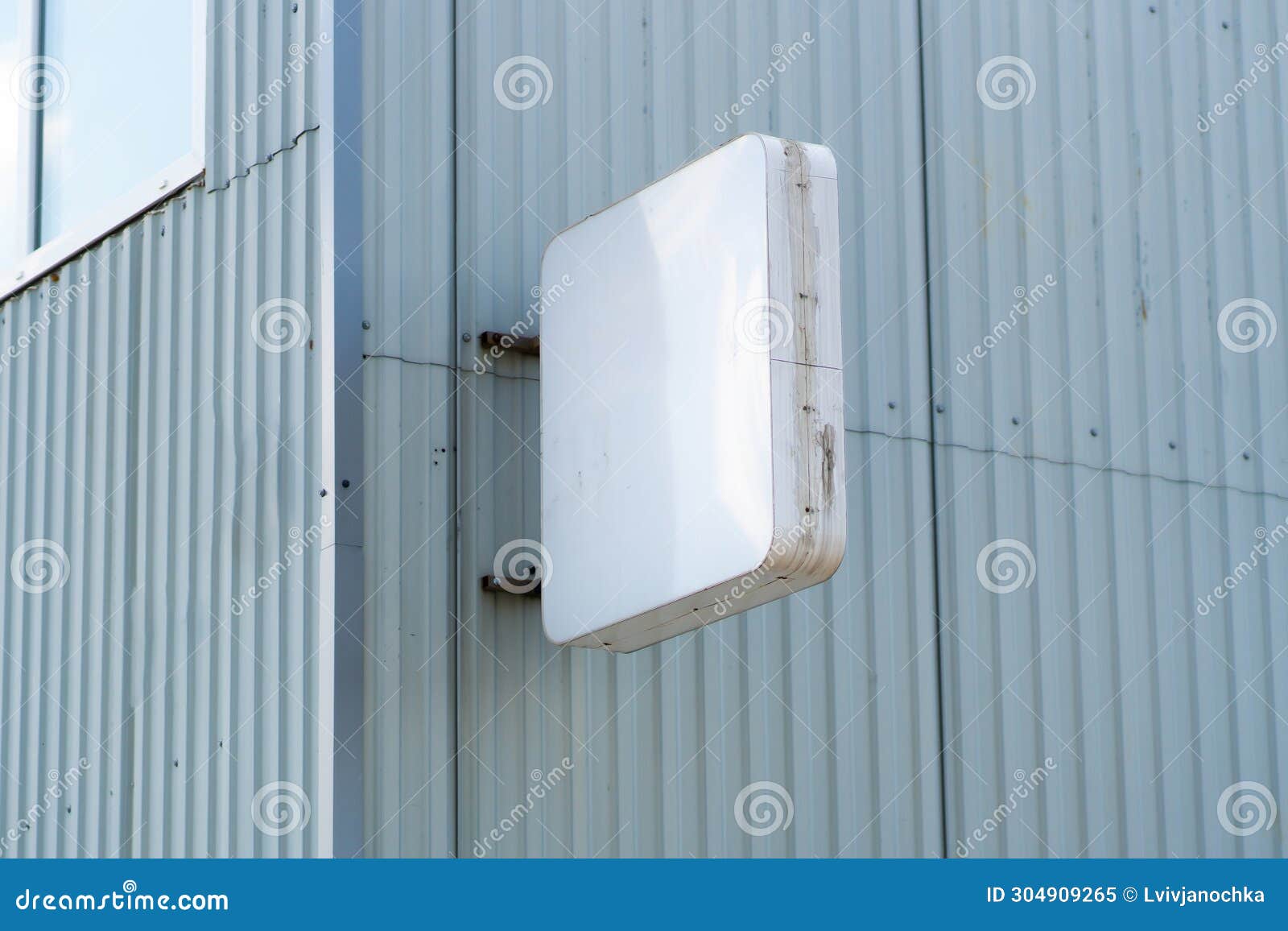 Rectangular Light Box with Company Name on Concrete Building Wall