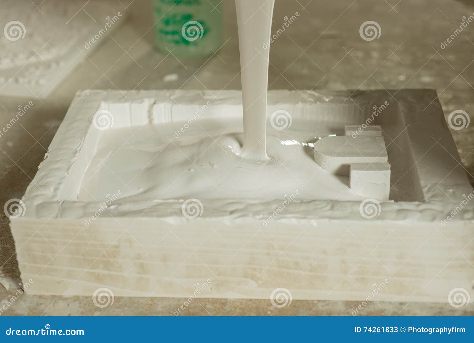 rectangular mold nearly filled with liquid plaster