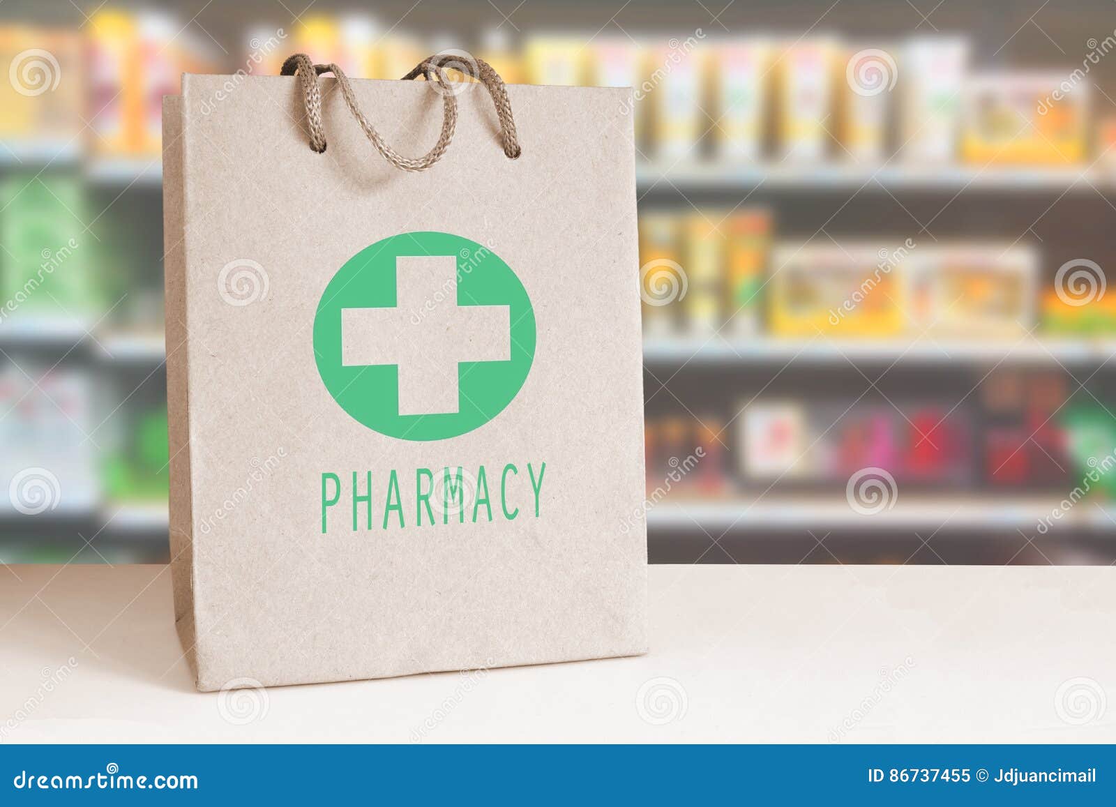 recycled paper bag with a green pharmacy logo in a drugstore. empty copy space