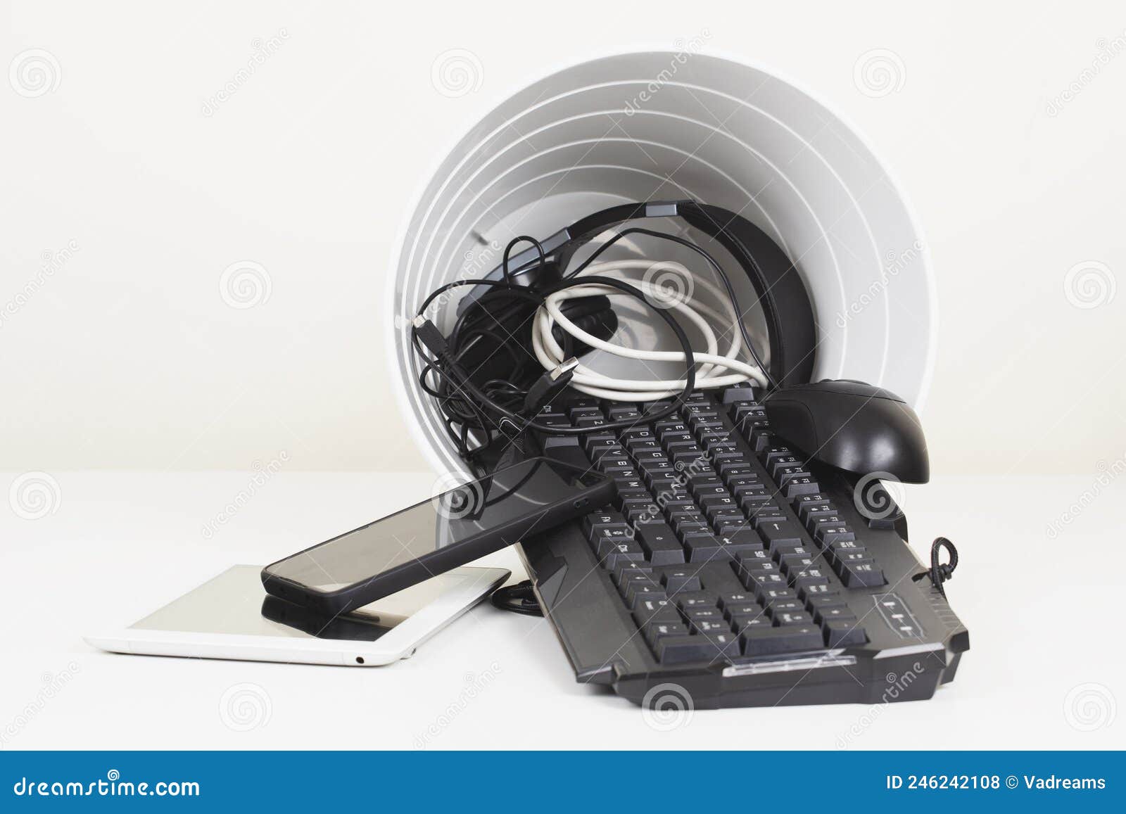 Recycling Bin and Old Digital Tablet, Cell Phone, Headphone, Cords and