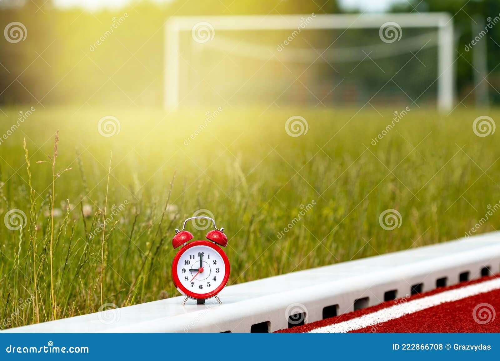 Red Alarm Clock on the Football Field Stock Photo Image of race