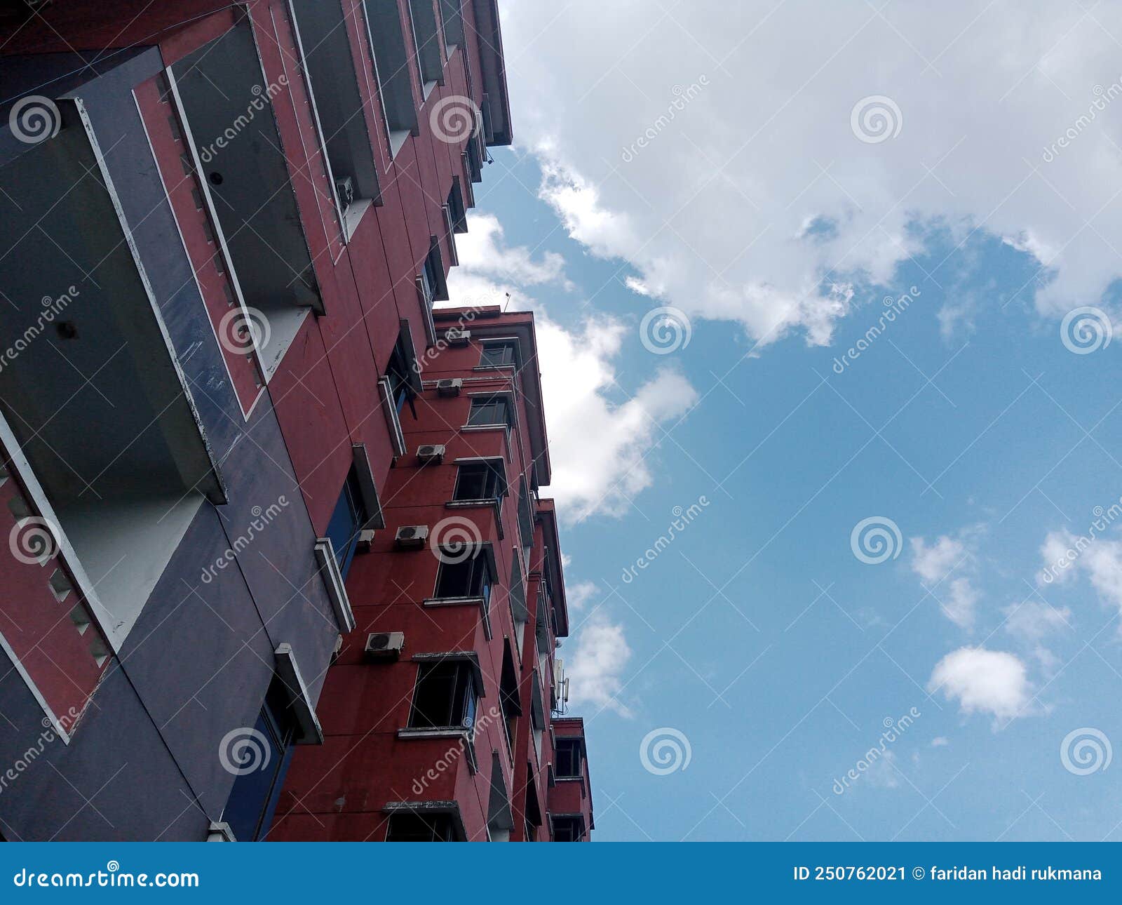 Red Apartment Building on a Clear Sky in the Daytime Stock Image