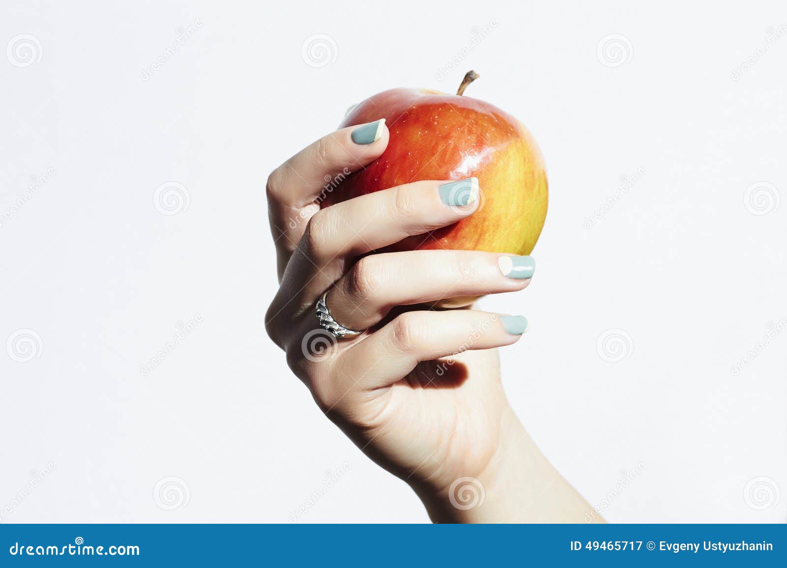 red apple in hand with manicure.female hands.beauty salon woman shellac polish