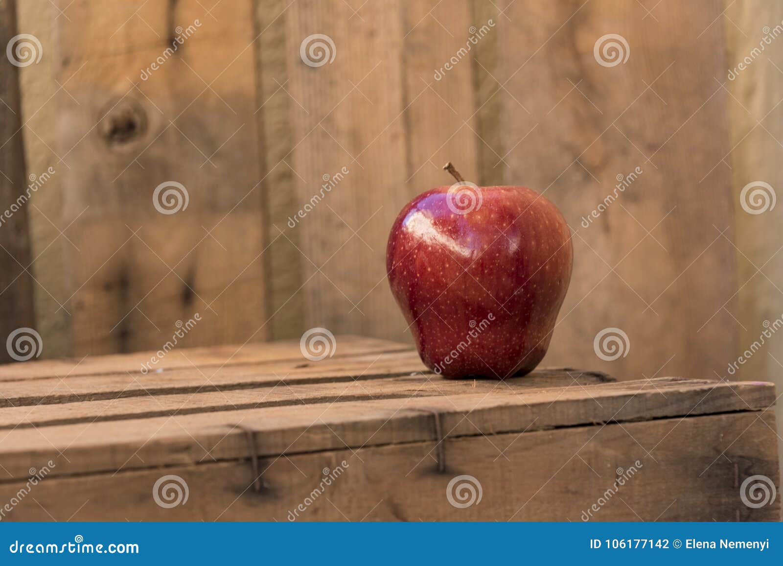 red apple on an old wooden table