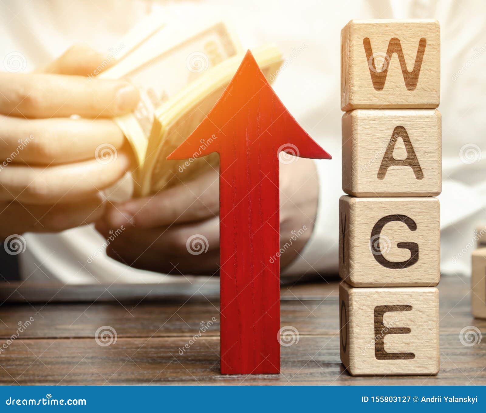 red arrow up near wooden blocks with the word wage and a businessman. salary increase concept. wages rate. revenue growth and
