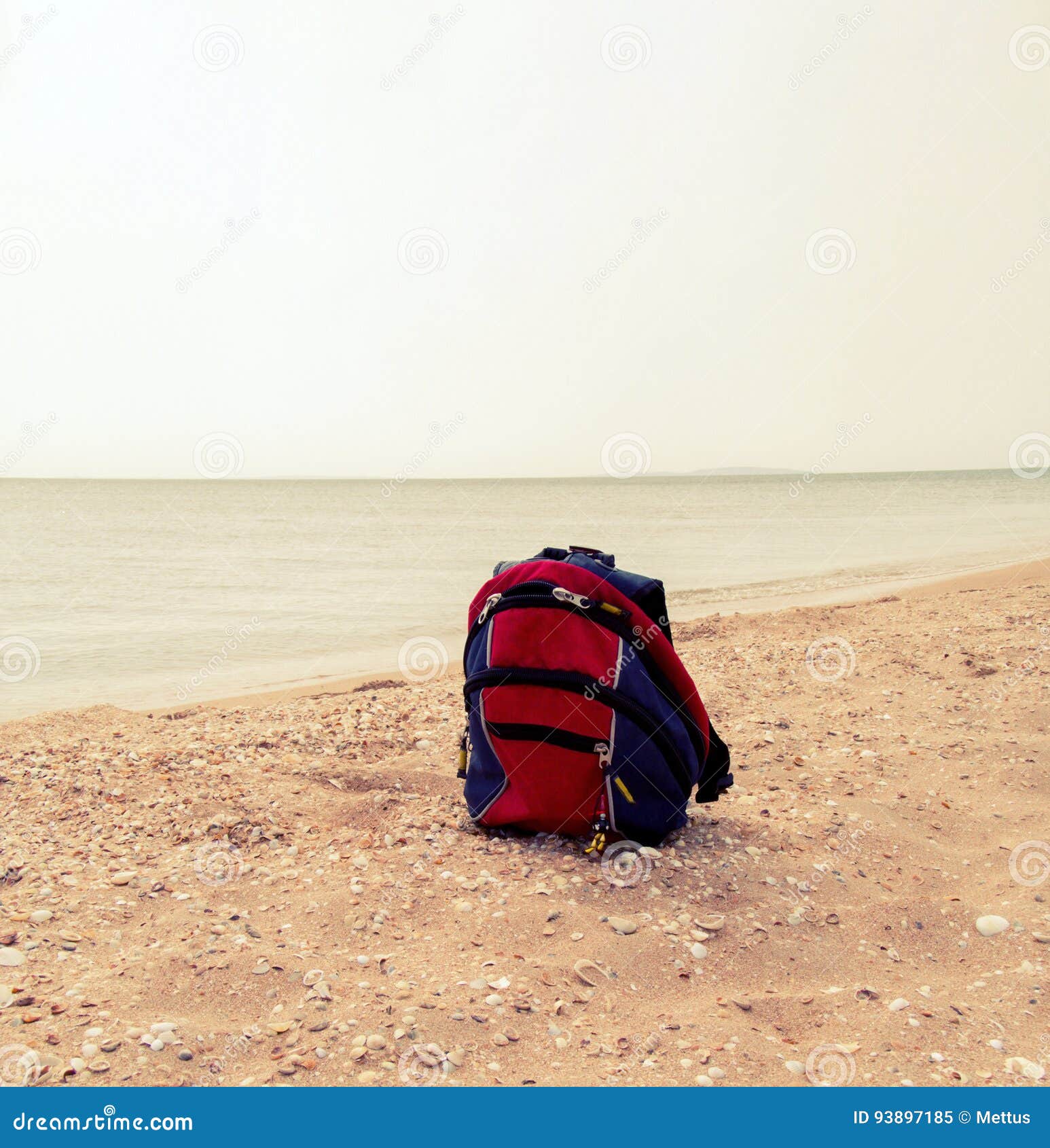 Red Backpack on the Sandy Sea Beach, a Lot of Copyspace Stock Image