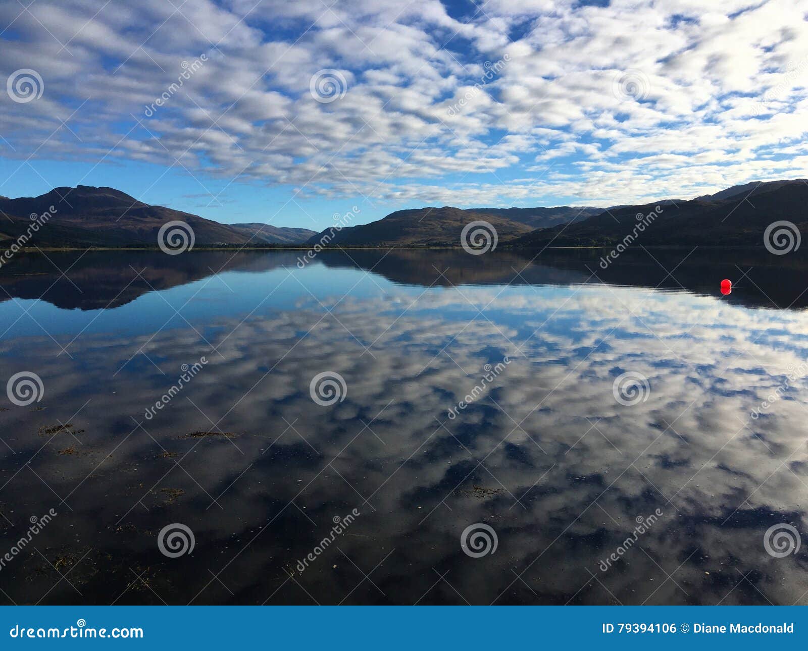 Red ball on Loch Carron stock photo. Image of ball, reflections - 79394106