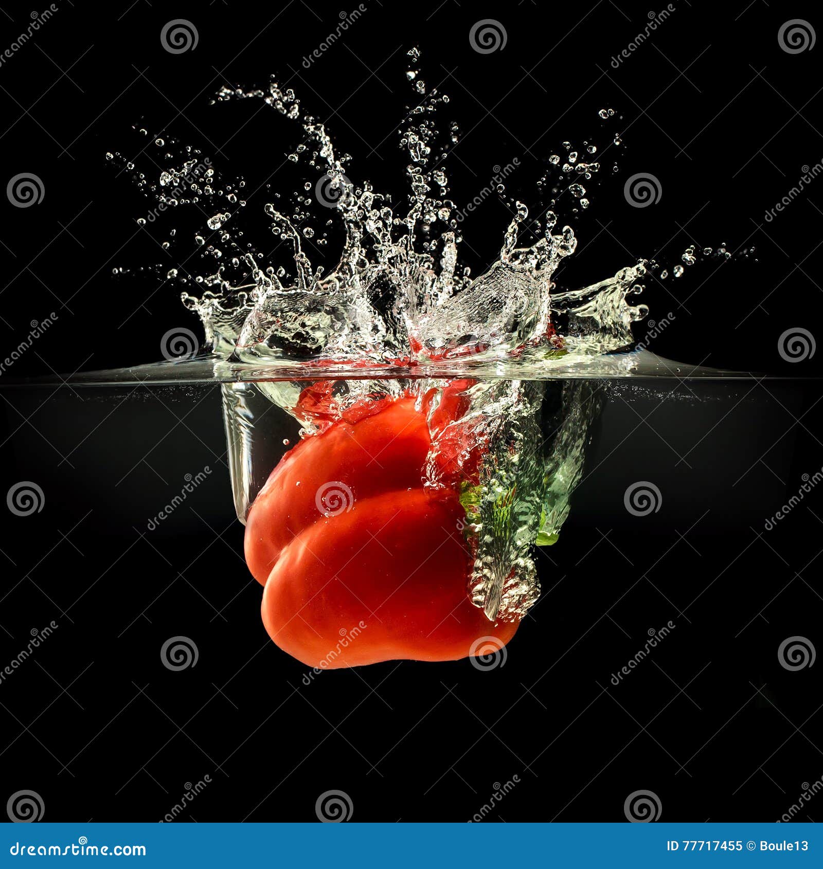 Red Bell Pepper Falling in Water with Splash on Black Background Stock