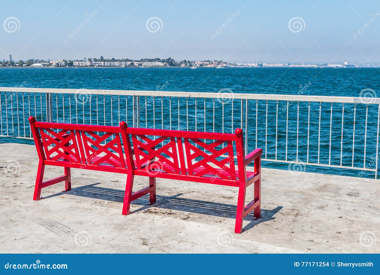 red bench on pier at cesar chavez park