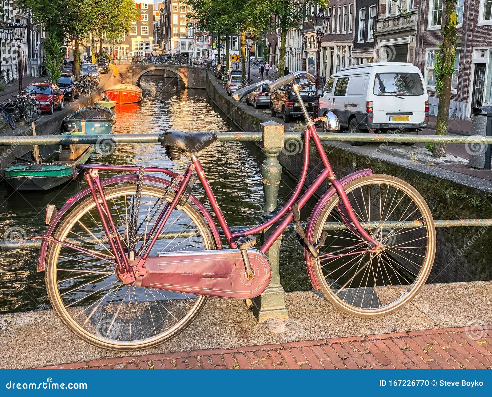 Red Bicycle Leaning on Canal Railing in Amsterdam Stock Photo - Image ...