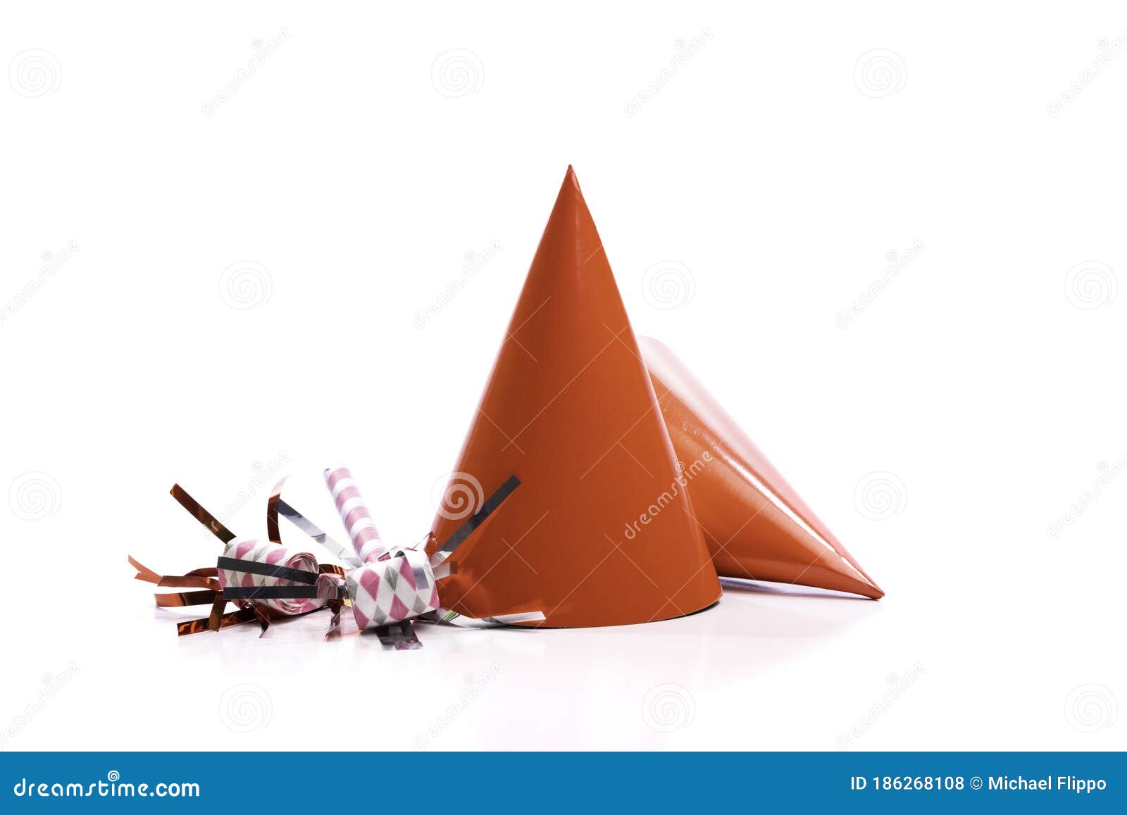 Red Birthday Hats and Noisemakers on a White Background. Stock Photo