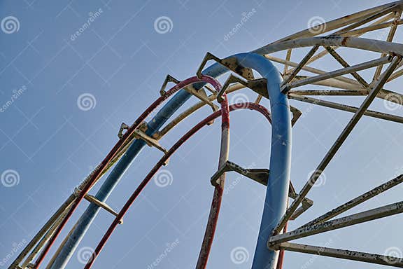 Red and Blue Roller Coaster Tracks Against Blue Sky, Upward View Stock ...