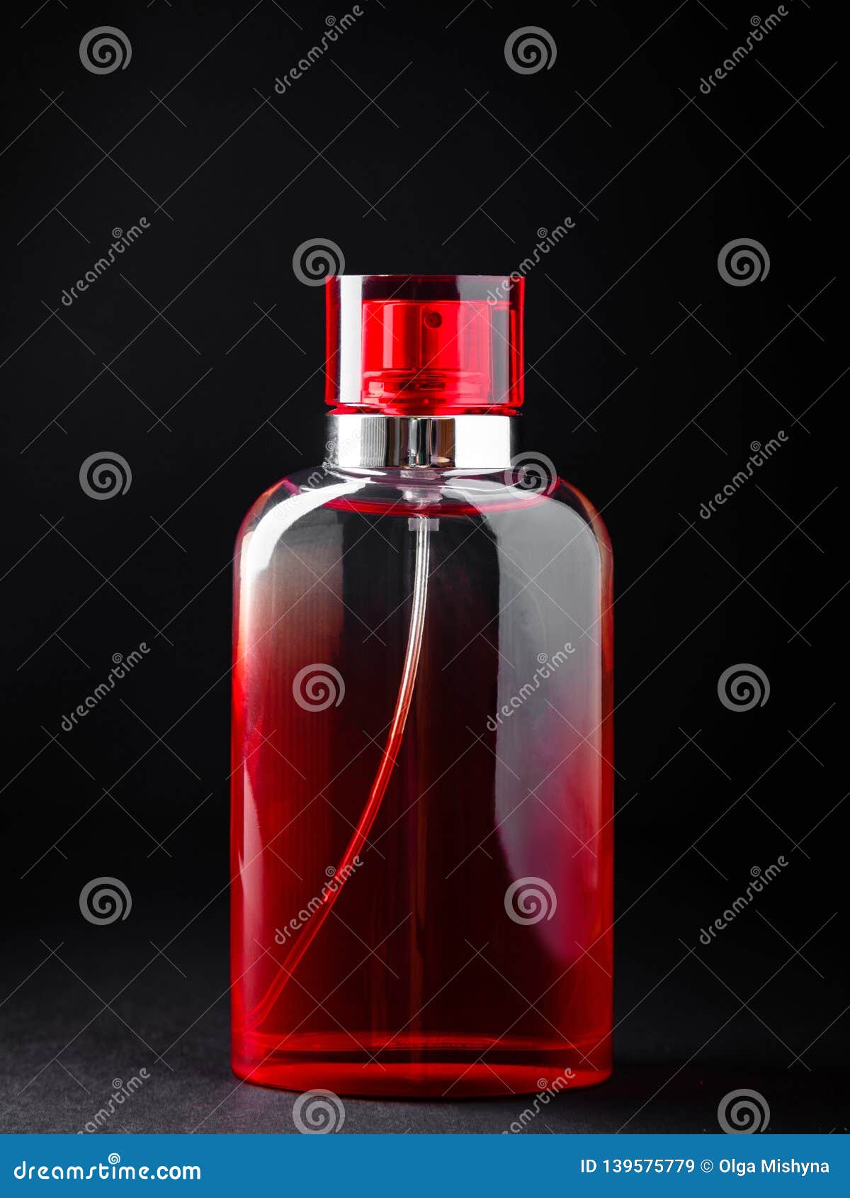 Red Bottle with Perfume or Cologne on Black Background. Stock Image