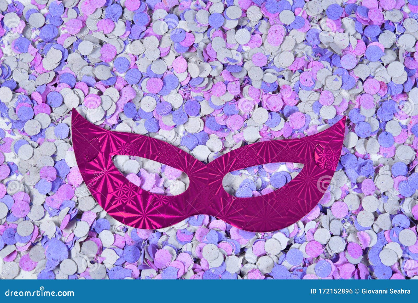 red brazilian carnival party costume mask on colorful confetti background with space for text